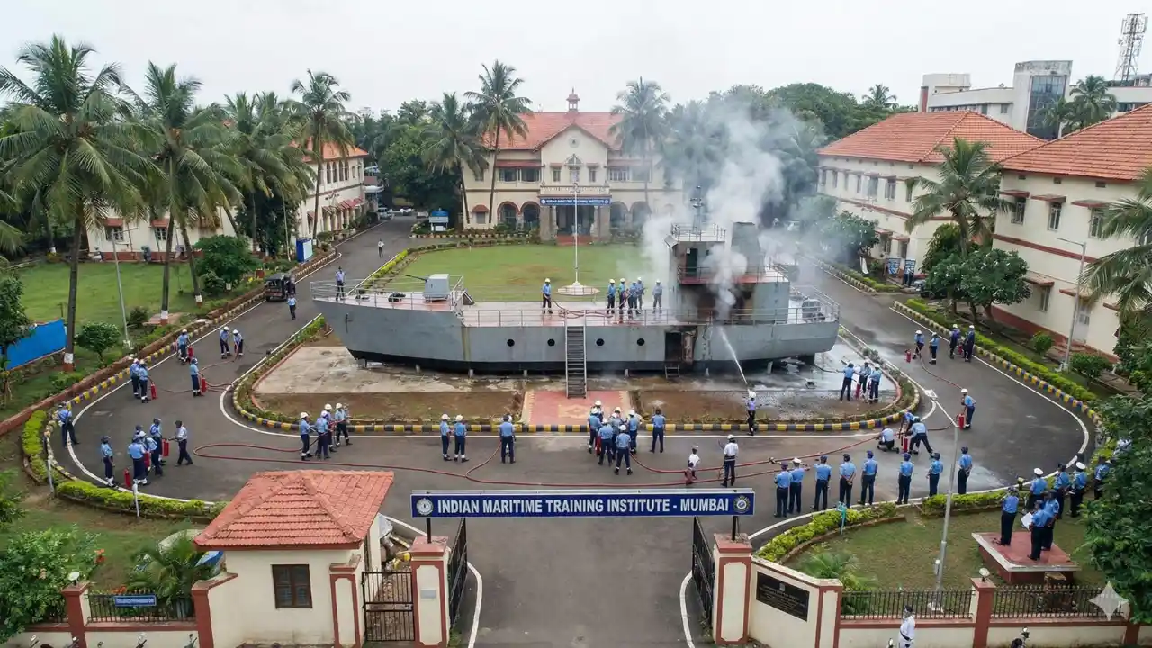 GP Rating Course क्या है? (2026) Fees, Eligibility, Salary | Merchant Navy 3 Indian maritime training institute campus view with students in uniform performing a fire fighting drill on a ship-in-campus model.